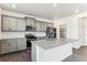 Modern kitchen with gray cabinets, granite countertops, stainless steel appliances, and a center island at 4635 Cattle Cross Trl, Castle Rock, CO 80104