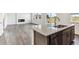 Open-concept kitchen with granite island, stainless steel appliances, and leads into the living area at 4635 Cattle Cross Trl, Castle Rock, CO 80104
