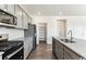 Spacious kitchen features stainless steel appliances, granite counters, subway tile backsplash and walk-in pantry at 4635 Cattle Cross Trl, Castle Rock, CO 80104