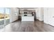 Open-concept kitchen with gray cabinets, stainless steel appliances, and a center island at 4635 Cattle Cross Trl, Castle Rock, CO 80104