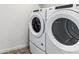 Close-up of a side by side washer and dryer in a well-lit laundry room at 4635 Cattle Cross Trl, Castle Rock, CO 80104
