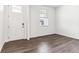 Inviting room with wood floors, a white front door, and a bright window at 4635 Cattle Cross Trl, Castle Rock, CO 80104