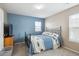 Cozy bedroom features a blue accent wall, carpeted floors, and natural light at 2810 Shadow Dance Dr, Castle Rock, CO 80109
