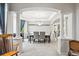 Dining area featuring white columns, gray chairs and a modern chandelier at 2810 Shadow Dance Dr, Castle Rock, CO 80109