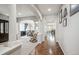 Bright hallway featuring hardwood floors, white columns and views of the dining area at 2810 Shadow Dance Dr, Castle Rock, CO 80109