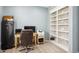 Bright home office with built in shelving, large windows, and neutral carpet at 2810 Shadow Dance Dr, Castle Rock, CO 80109
