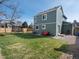 Spacious fenced backyard with healthy lawn, featuring patio, grill, and play trampoline for outdoor enjoyment at 5557 S Simms Way, Littleton, CO 80127
