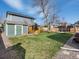 Spacious backyard with a shed, playhouse, and trampoline; perfect for outdoor activities at 5557 S Simms Way, Littleton, CO 80127