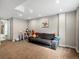 Finished basement area with carpet, neutral walls, and a cozy seating area at 5557 S Simms Way, Littleton, CO 80127