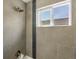 Close-up of the shower and bath showing the window with view to outside at 5557 S Simms Way, Littleton, CO 80127