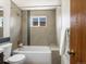 Updated bathroom featuring modern fixtures, stylish tile accents, and a bathtub at 5557 S Simms Way, Littleton, CO 80127