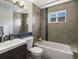 Updated bathroom featuring modern fixtures, stylish tile accents, and a bathtub at 5557 S Simms Way, Littleton, CO 80127