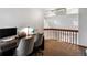 Upstairs hallway overlooking main level with natural light at 5557 S Simms Way, Littleton, CO 80127