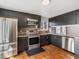 Modern kitchen featuring stainless steel appliances, dark cabinetry, and a breakfast bar at 5557 S Simms Way, Littleton, CO 80127
