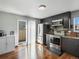 Kitchen featuring stainless steel appliances, hardwood floors, access to outdoor patio at 5557 S Simms Way, Littleton, CO 80127