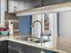 Kitchen sink detail with granite countertops, modern faucet, and dark wood cabinets at 5557 S Simms Way, Littleton, CO 80127