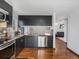Charming kitchen with stainless steel appliances, granite counters, and hardwood floors at 5557 S Simms Way, Littleton, CO 80127