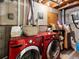 Basement laundry area featuring a front loading washing machine and storage at 5557 S Simms Way, Littleton, CO 80127