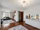 Open-concept living space showcasing the dining area, staircase, and living room with hardwood floors at 5557 S Simms Way, Littleton, CO 80127