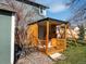 Backyard playhouse made of wood provides a charming space for imaginative play with a seating area at 5557 S Simms Way, Littleton, CO 80127