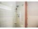 Sleek bathroom featuring tiled shower with glass door, built in shelving, and updated fixtures at 1863 Wazee St # 4E, Denver, CO 80202