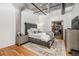 Modern bedroom with tufted headboard, ceiling fan, and walk-in closet at 1863 Wazee St # 4E, Denver, CO 80202