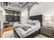 Comfortable bedroom featuring exposed ductwork, concrete pillar, and stylish furniture at 1863 Wazee St # 4E, Denver, CO 80202