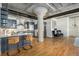 Well-lit kitchen with stainless steel appliances, updated cabinetry and eat-in island open to living room at 1863 Wazee St # 4E, Denver, CO 80202