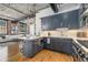 Modern open concept kitchen with eat in island, stainless steel appliances, and open view to living space at 1863 Wazee St # 4E, Denver, CO 80202