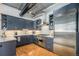 A modern kitchen featuring stainless steel appliances, sleek cabinetry, and beautiful hardwood floors at 1863 Wazee St # 4E, Denver, CO 80202