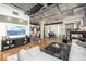 Open living area showcasing kitchen, fireplace, exposed ceilings, and hardwood flooring at 1863 Wazee St # 4E, Denver, CO 80202