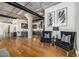 Open-concept living room showcasing hardwood floors, exposed ductwork, and a modern kitchen with a large central island at 1863 Wazee St # 4E, Denver, CO 80202