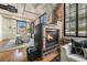 Living area with brick fireplace, large windows, and a dining area with modern light fixture at 1863 Wazee St # 4E, Denver, CO 80202