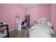 Pink bedroom features a white bed frame and furniture for a playful and charming aesthetic at 5255 Memphis St # 811, Denver, CO 80239