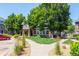 Community clubhouse featuring stone and siding exterior, lush landscaping, and inviting walkway at 5255 Memphis St # 811, Denver, CO 80239