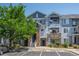 Attractive exterior of townhome with stone accents, covered patios, and dedicated parking spots at 5255 Memphis St # 811, Denver, CO 80239