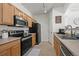 Functional kitchen with wood cabinets, stainless steel appliances, and ample counter space at 5255 Memphis St # 811, Denver, CO 80239