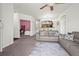 Inviting living room with open floor plan and neutral tones is carpeted and furnished with gray sofas at 5255 Memphis St # 811, Denver, CO 80239