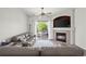 Bright living room with sofas, ceiling fan, fireplace, and natural light from sliding glass doors to balcony at 5255 Memphis St # 811, Denver, CO 80239