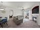 Comfortable living room featuring a fireplace, gray sofas, and a view of the outdoors from the sliding glass door at 5255 Memphis St # 811, Denver, CO 80239