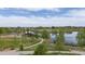 A scenic view of the community pond and gazebo nestled among mature trees and walking paths at 5255 Memphis St # 811, Denver, CO 80239