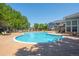 Large community pool with lounge chairs, shade arbors, and well-manicured landscaping in view at 5255 Memphis St # 811, Denver, CO 80239