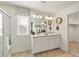 Bright bathroom features double sinks, white cabinets, a large mirror, and a shower at 27664 E Byers Ave, Aurora, CO 80018