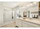 Bathroom with double vanity, walk-in shower, and natural light from a window at 27664 E Byers Ave, Aurora, CO 80018