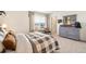 Cozy bedroom with neutral tones, a decorative dresser, and playful decor at 27664 E Byers Ave, Aurora, CO 80018
