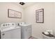 Bright laundry area with modern appliances and charming decor at 27664 E Byers Ave, Aurora, CO 80018