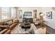 Cozy living room with wood floors, stylish furnishings, and bright windows at 27664 E Byers Ave, Aurora, CO 80018