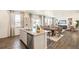 Open-concept layout connecting kitchen, dining, and living areas filled with natural light at 27664 E Byers Ave, Aurora, CO 80018
