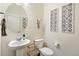 Stylish powder room with modern fixtures and decor, and a sleek pedestal sink at 27664 E Byers Ave, Aurora, CO 80018