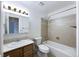 Well-lit bathroom features a vanity with storage, toilet, and a tiled shower-over-tub at 630 S Youngfield Ct, Lakewood, CO 80228
